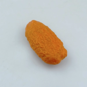 Detailed macro view of realistic faux dried red date model with textured orange peel