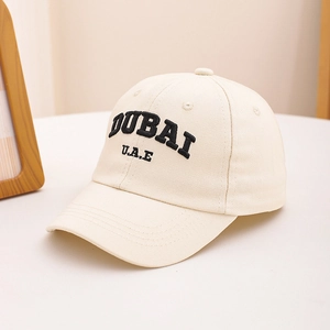Close-up of beige cotton baseball cap with 3D black Dubai embroidery and curved brim