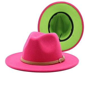 Detailed view of pink wool fedora with neon green interior and brown leather belt buckle