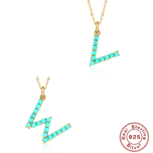Detailed close-up of S925 sterling silver gold chain with turquoise initial L and W pendants