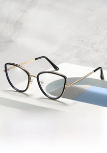 Detail of stylish black cat-eye glasses with golden bridge on a display pedestal