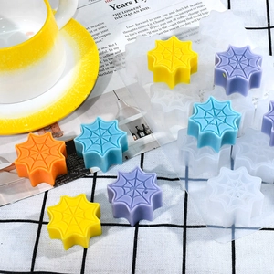 Detail of spider web silicone mold with colorful resin samples on plaid background