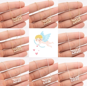 Macro detail of custom birth year pendants 2016-2019 in gold and silver finishes