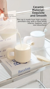 Detailed close-up of cream ceramic mug with bread-shaped handle and matching spoon