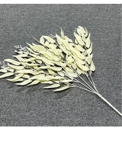 Detailed close-up of pale yellow silk willow leaves with multiple artificial branches