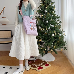Quilted purple tote bag with cartoon print in a cozy winter lifestyle setting