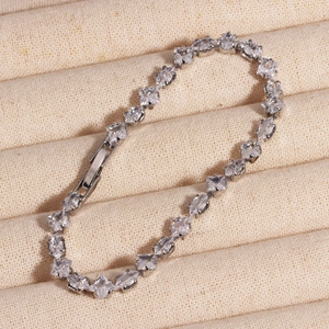 Macro view of silver chain bracelet with zircon stones and secure fold-over clasp