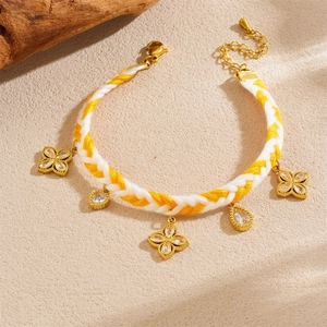 Handmade woven twisted chain bracelet with gold-plated floral and teardrop pendants