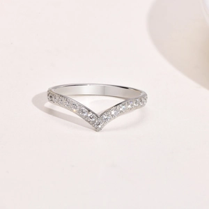 Macro detail of V-shaped silver steel ring with pavé-set shimmering zircon stones