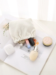 Close-up of a white corduroy mini storage pouch on a magazine for small accessories