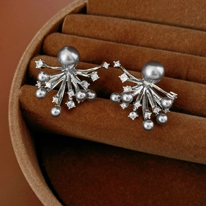 Close-up of starburst silver stud earrings with grey pearls and cubic zirconia stones