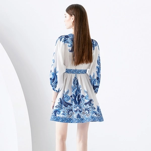 Back view of a mini dress with blue baroque print, V-neck, and puffed lantern sleeves