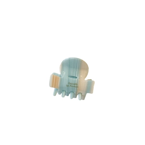 Blue and beige acetate hair claw clip with marble pattern and gold lettering