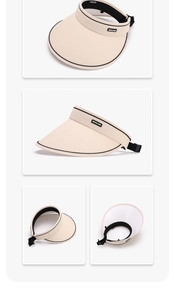 Detail view of the beige sun visor with black piping, adjustable strap, and logo label