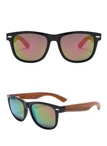 Detail of oval frame sunglasses featuring natural wood temples and colorful gradient lenses