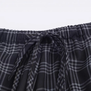 Women's casual plaid shorts featuring a drawstring waist and black-grey checkered pattern