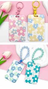 Pastel floral card holders with beaded bracelets and metal clips in macro view