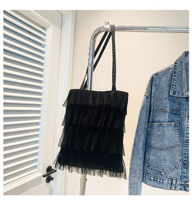 Detail of black tiered mesh ruffle shoulder bag with lightweight tulle layers