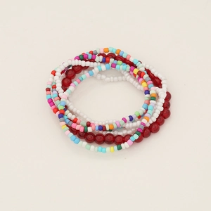 Close-up of stacked bohemian seed bead bracelets in vibrant multi-colored layers