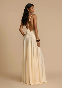 Detailed back view of a cream lace sleeveless dress with open back and floor-length hem