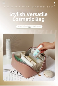 Detail showing inner compartments and large storage capacity of pink PU makeup bag