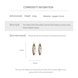Detailed view of 5.5cm gold hoop earrings with multi-colored rectangular cubic zirconia