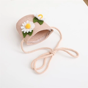 Detailed macro view of a beige woven straw bag with white daisies and zipper closure