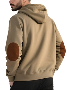 Detail view of khaki hoodie with brown oval elbow patches and soft cotton texture
