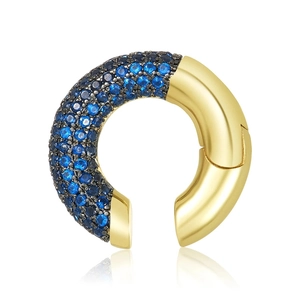 Detail of luxury C-shaped gold ear cuff with blue and black zircon stones on white background