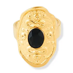 Vintage gold oval ring with embossed patterns and a large faceted black onyx gemstone