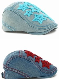 Detail of denim flat caps featuring embroidered plush stars in blue and red colors