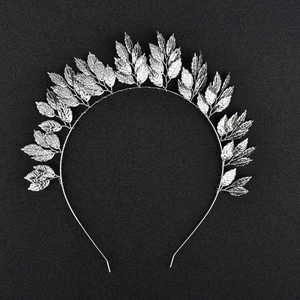 Detail view of the silver metallic leaf headband with intricate branch design
