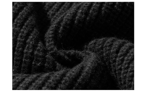 Detailed close-up of high-quality heavy black ribbed knit texture on a retro hoodie