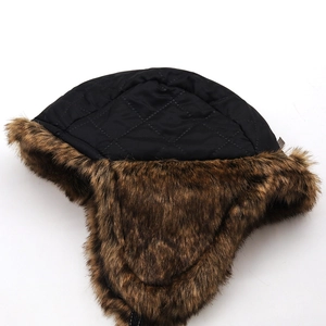 Close-up of quilted waterproof top and thick faux fur lining on a winter trapper hat