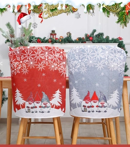 Detail of red and grey burlap Christmas chair covers with gnome and snowflake patterns