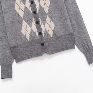 Casual grey knit cardigan with argyle pattern and round black buttons in flat lay view