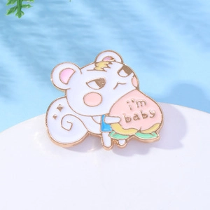 Detailed close-up of a white squirrel enamel pin holding a pink peach with I'm Baby text
