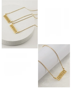 Detail of 18K gold plated stainless steel MAMA necklace with minimalist letter pendant