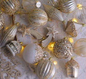 Detailed view of champagne and cream Christmas ornaments with glitter and pearls