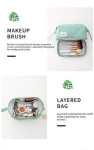 Dual-layer travel makeup bag in mint green featuring a dedicated brush compartment
