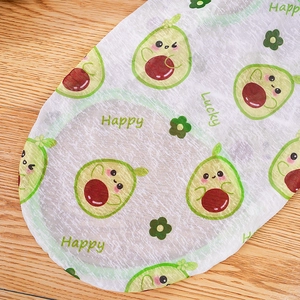 Close-up of lightweight dog vest fabric with cartoon avocado and Happy Lucky text