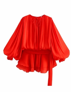 Detailed view of red lantern sleeve dress with drawstring waist and ruffle hemline