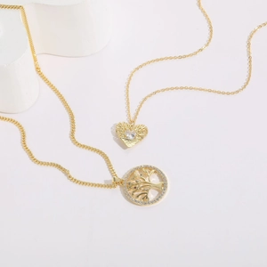 Detailed view of 14K gold plated necklaces featuring heart and tree of life zircon pendants