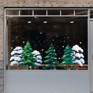 Close-up of white and green snowy pine tree static window stickers with stars