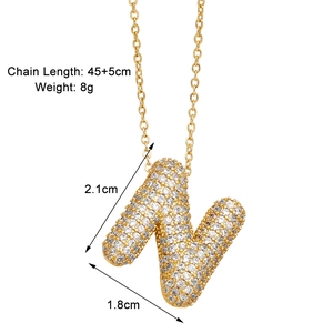 Macro shot of gold letter N pendant necklace with paved cubic zirconia details