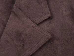 Close-up of the stitching detail and faux suede texture on a dark brown jacket collar
