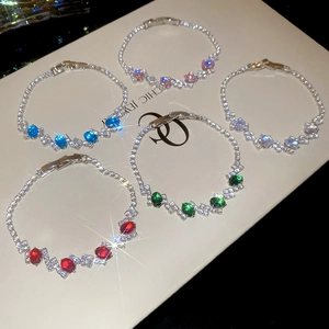 Detailed view of silver oval zircon bracelets in five vibrant colors on a display board
