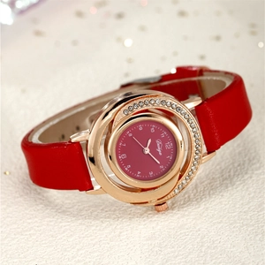 Macro detail of red leather strap and sparkling rhinestone bezel on rose gold watch