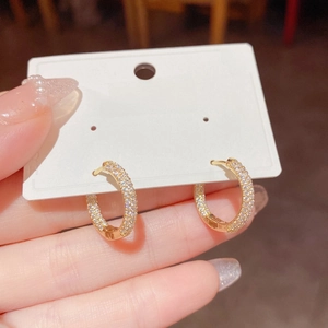 Exquisite gold C-shaped hoop earrings with micro-paved cubic zirconia and pearls
