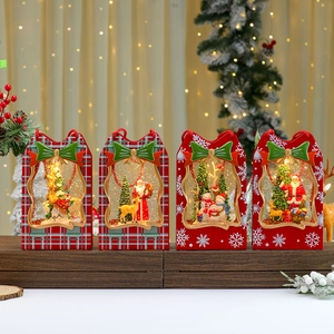 Set of four Christmas lanterns with Santa, snowmen and reindeer motifs in red and green